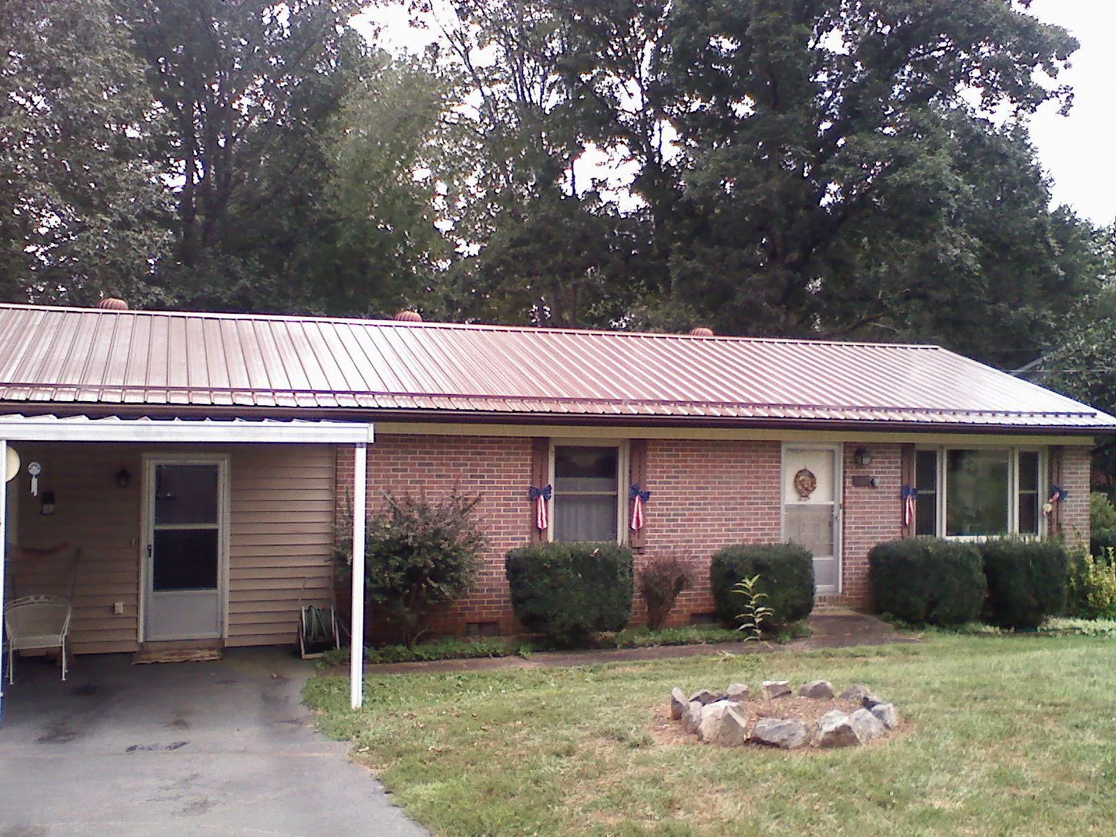 Bronze metal roof and carport on a brick ranch home — Roof Repair work by our crew in Catasauqua
