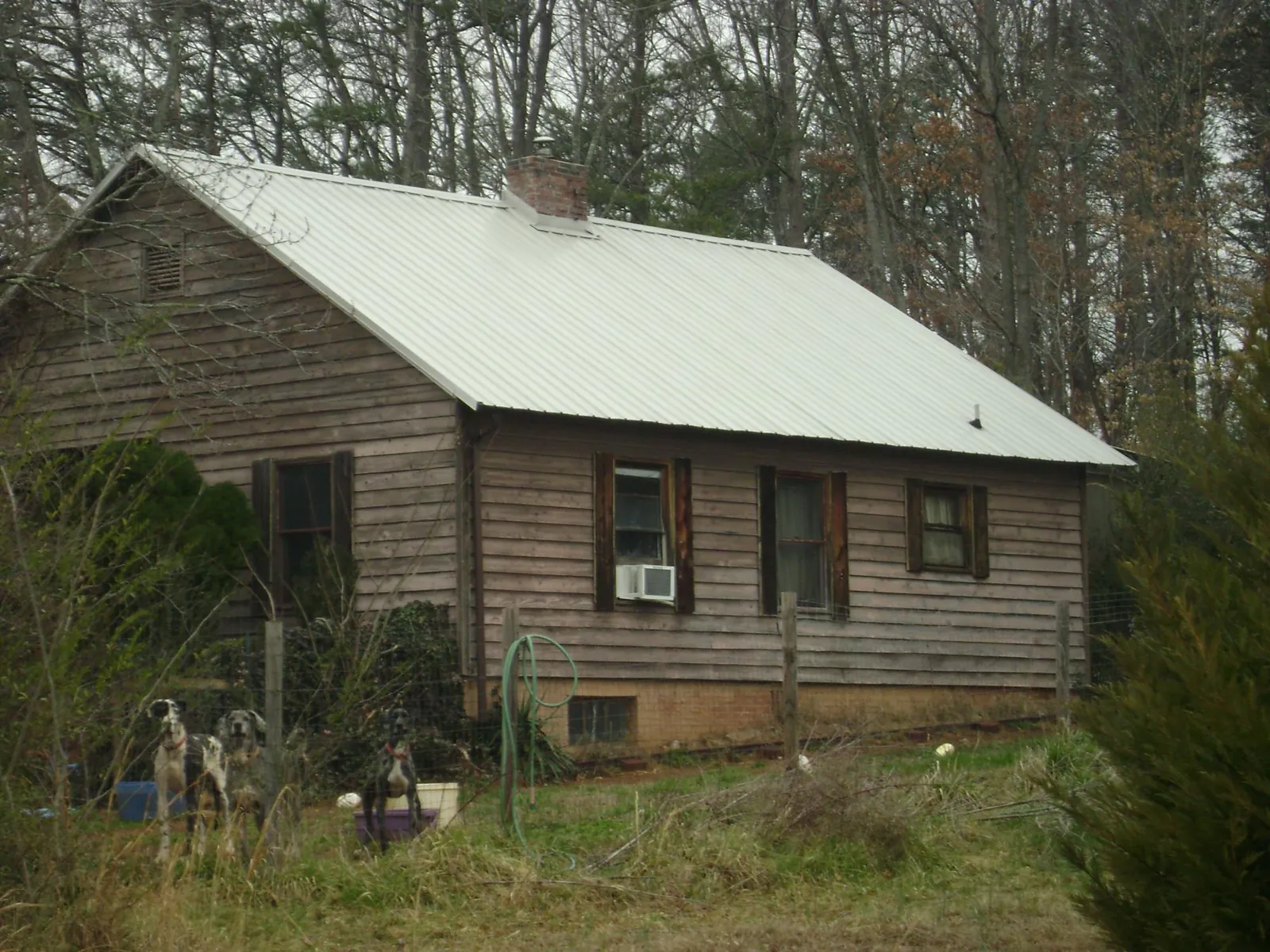 White metal roof on an old wood sided farmhouse, from a Metal Roof Installation job in Catasauqua